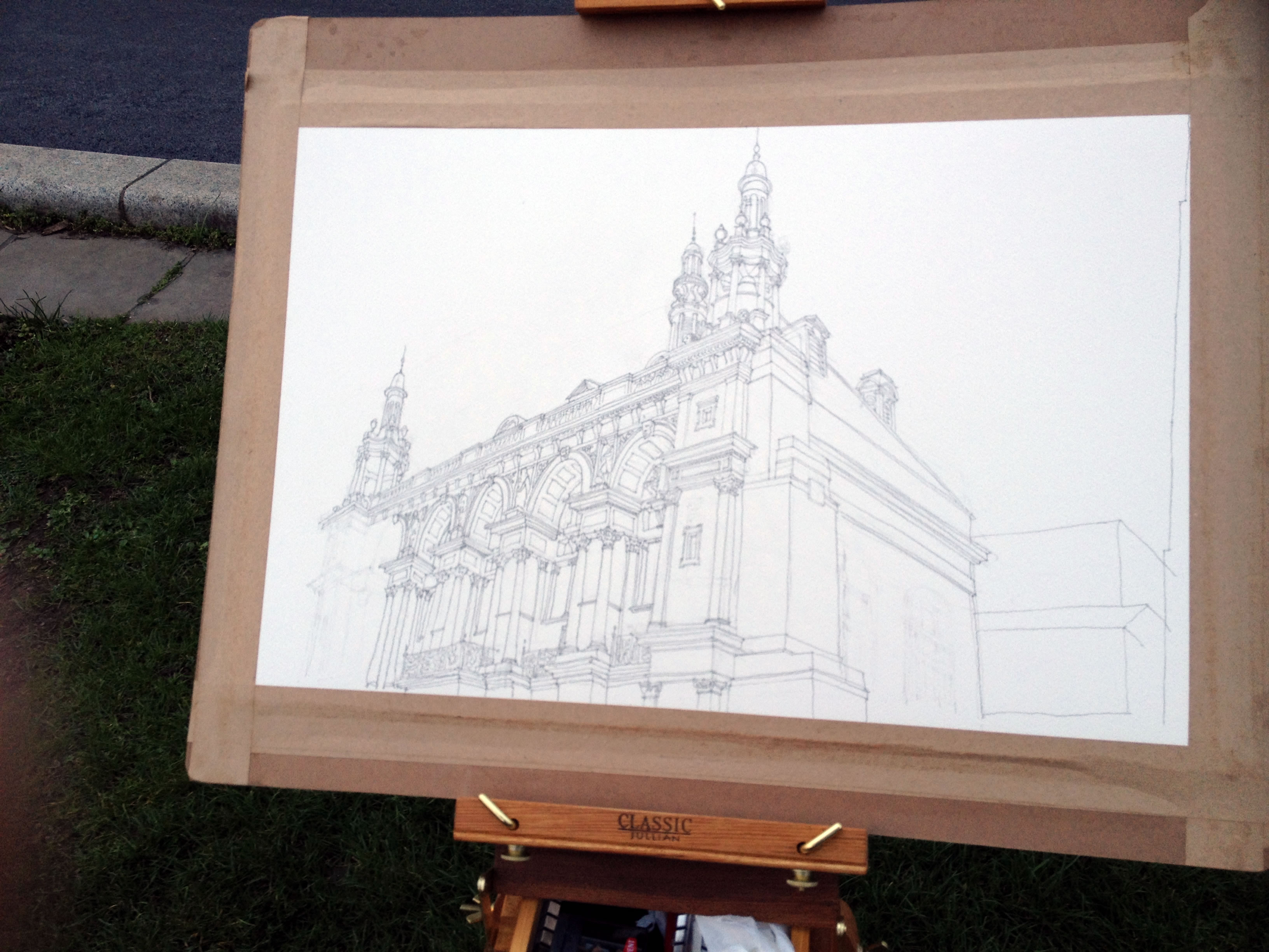 Sketching the City of London school while sitting on a traffic island near Blackfriars bridge in London City of London